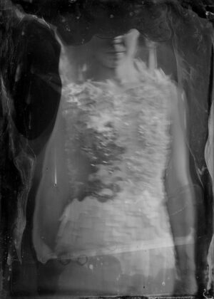 A woman in a white dress is standing inside of a bag.