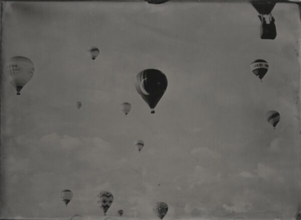 A group of hot air balloons flying in the sky.