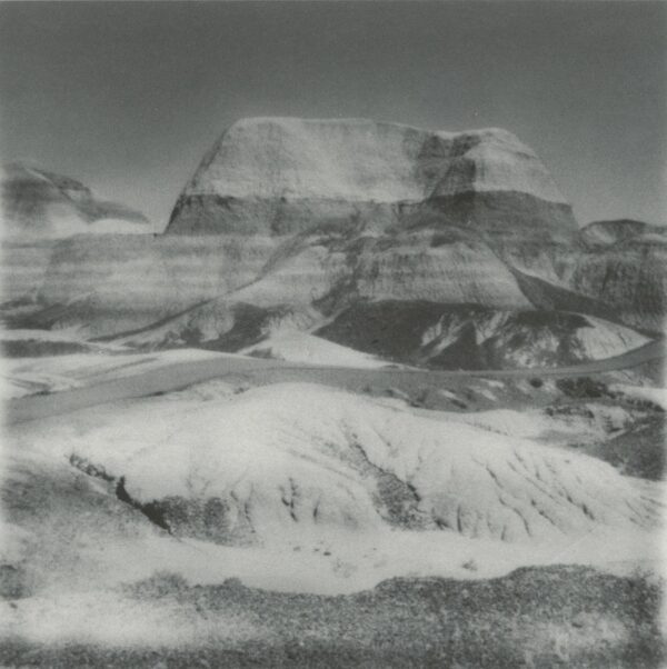 A black and white photo of a mountain with snow on it.