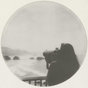 A woman is taking pictures of the ocean.