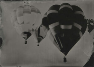 A black and white photo of three balloons.