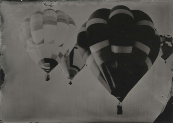A black and white photo of three balloons.