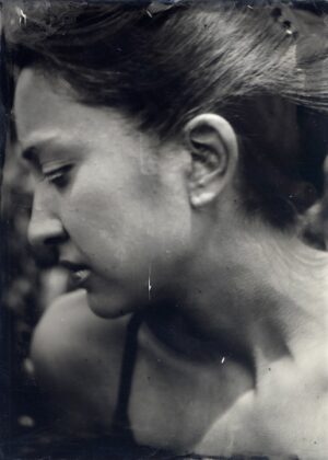 A woman with long hair and a bare face.