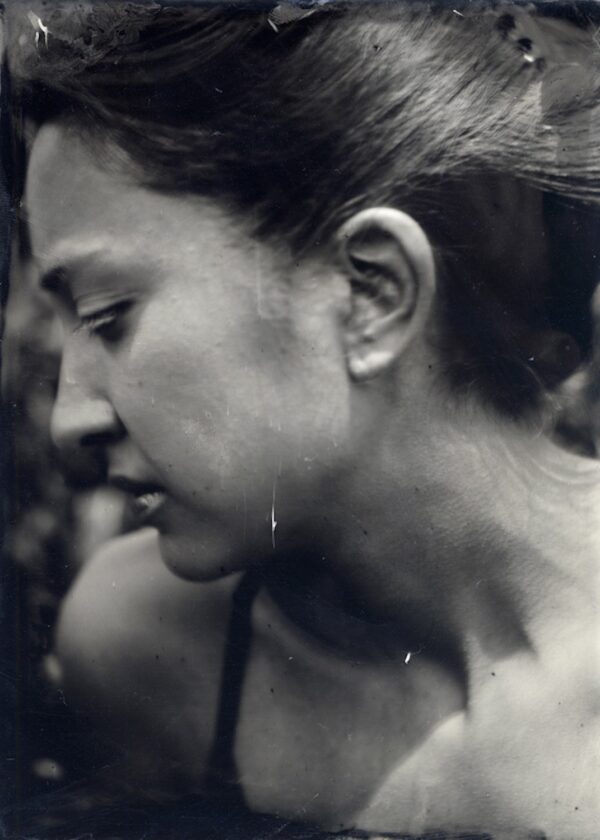 A woman with long hair and a bare face.