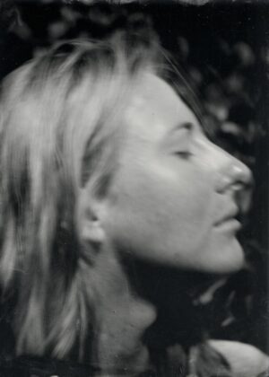 A woman with long hair is looking up.