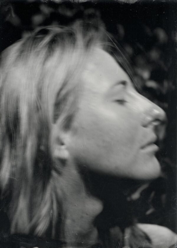 A woman with long hair is looking up.