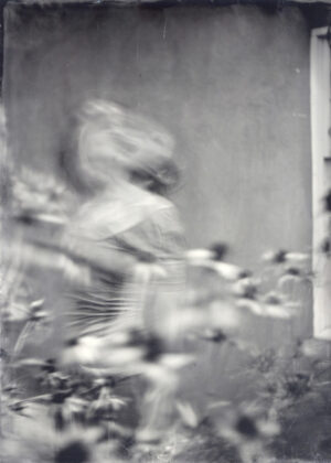 A blurry image of a baseball player in motion.