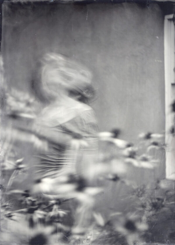 A blurry image of a baseball player in motion.
