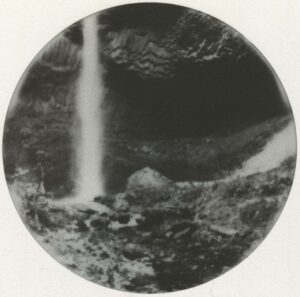 A black and white photo of a waterfall.