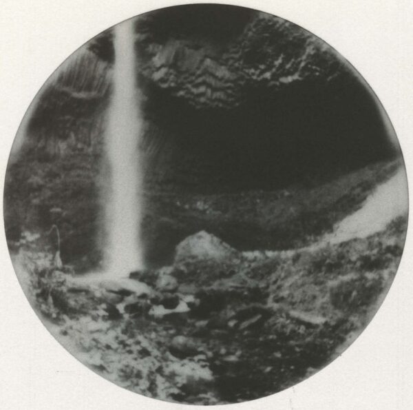 A black and white photo of a waterfall.