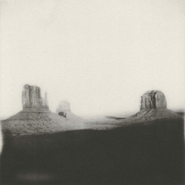 A black and white photo of two mountains