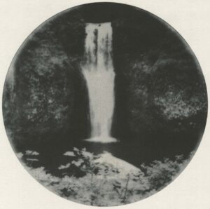 A black and white photo of a waterfall.