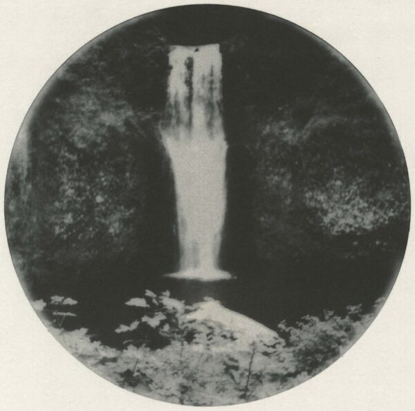 A black and white photo of a waterfall.