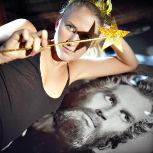 A woman holding a star in front of a man.