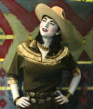 A woman in a cowboy hat and brown shirt.