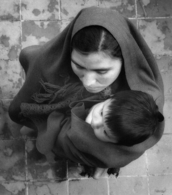 A woman holding a child in her arms.