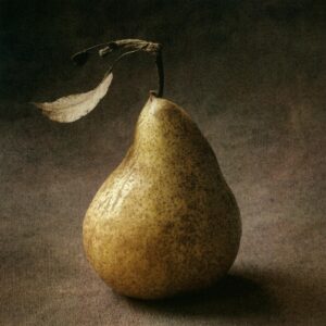 A pear with leaves on it's stem.