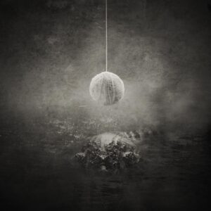 A ball hanging from string in the middle of a room.