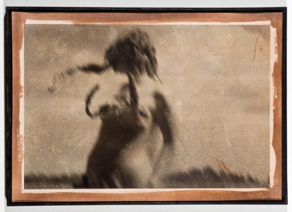 A blurry picture of a naked woman in the grass.