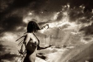 A woman in a bikini is standing on the beach