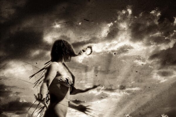 A woman in a bikini is standing on the beach