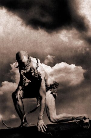 A man with no shirt and chains on his back.