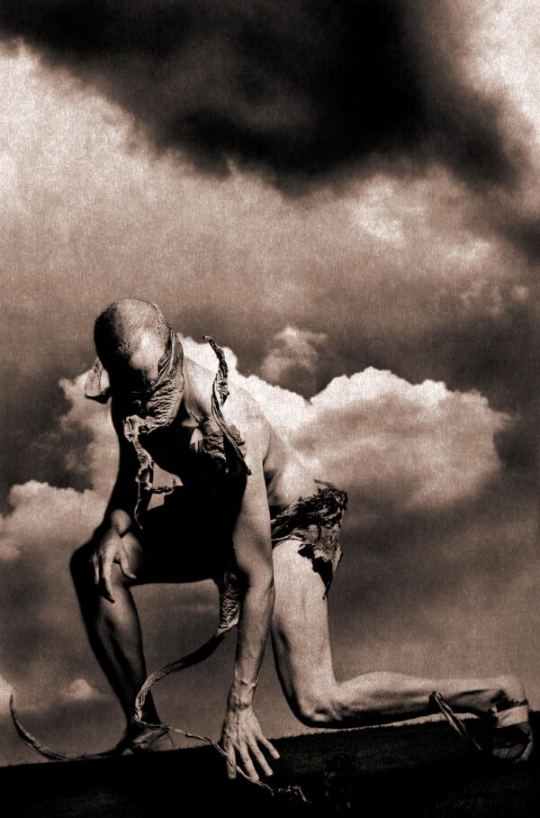 A man with no shirt and chains on his back.
