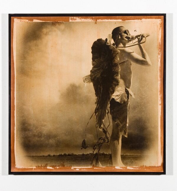 A man standing in front of smoke holding a pipe.