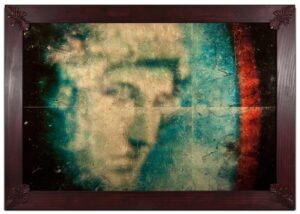 A blurry picture of a man 's face in a frame.