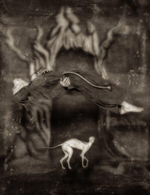 A black and white photo of a dog in the middle of a painting.