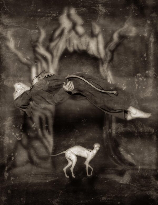 A black and white photo of a dog in the middle of a painting.