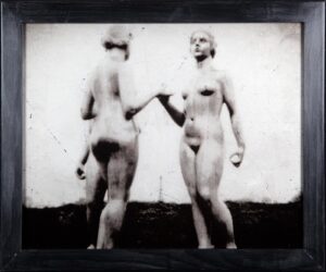 Two women holding hands in a black and white photo.