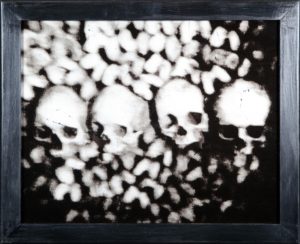 A black and white photo of skulls in the middle.