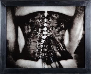 A woman wearing a corset with lace up.