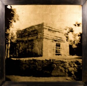 A picture of an old building in the middle of nowhere.
