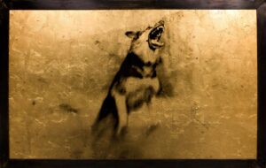 A dog is barking in the air with its mouth open.