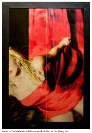 A woman in red is holding onto the pole
