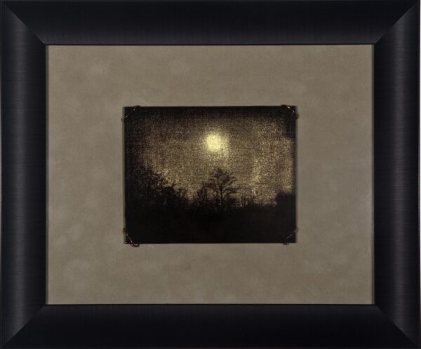 A painting of the moon and trees in a frame.