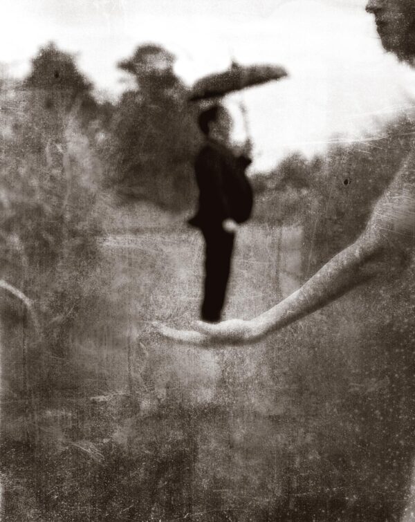 A blurry image of someone holding an umbrella