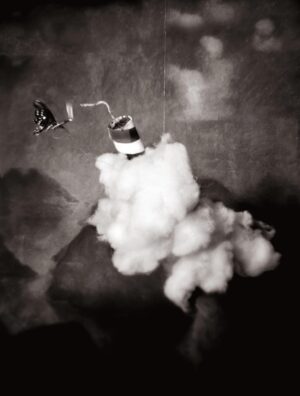 A black and white photo of smoke coming from the sky.