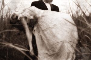 A man and woman in wedding attire standing next to each other.