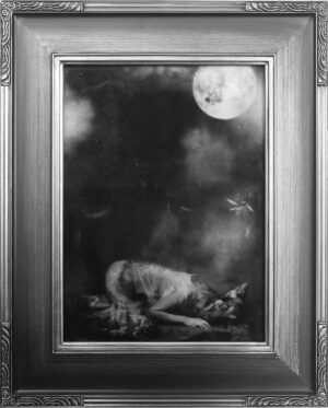 A black and white photo of a cat in the dark.