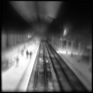 A blurry photo of people walking on the tracks.