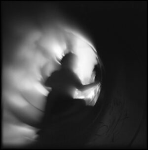 A blurry image of a person in the dark.