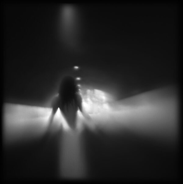 A blurry image of a person walking in the dark.