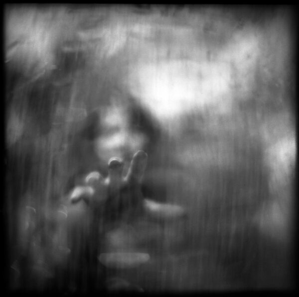A blurry image of a person with a camera.