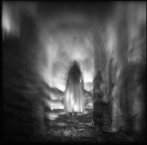 A blurry image of a person in the dark.