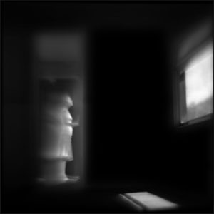A blurry image of a fire hydrant in the dark.