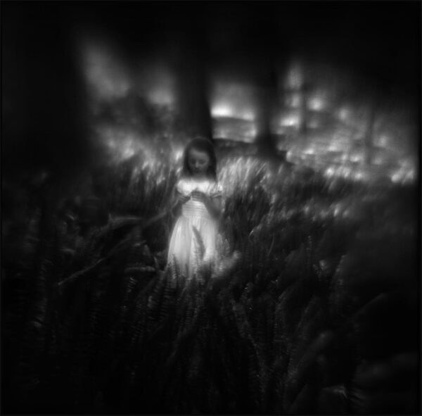 A blurry image of a woman in a dress