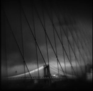 A black and white photo of the brooklyn bridge.